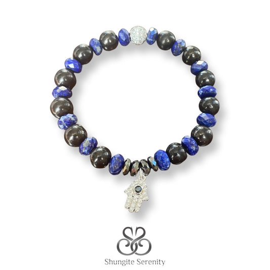 A bracelet with polished black shungite beads and blue lapis lazuli beads, featuring a Hamsa charm.